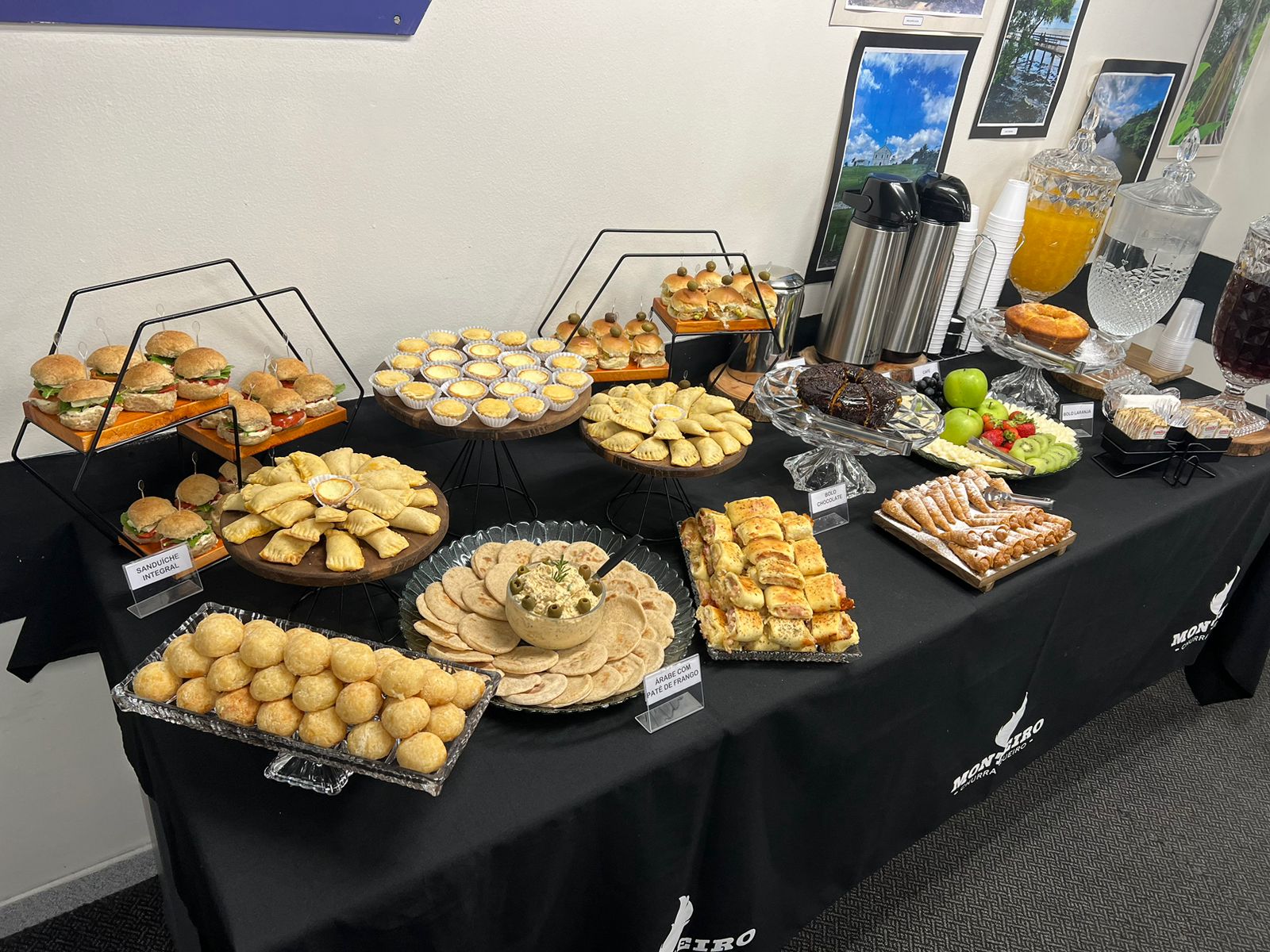 Mesa de buffet com lanches, salgadinhos e aperitivos de coffee break